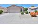Charming single-story home showcasing a well-maintained front yard with a spacious two-car garage at 426 N Santiago Trl, Casa Grande, AZ 85194