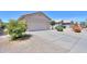 Single-story home featuring a two-car garage, low-maintenance landscaping and tile roof at 426 N Santiago Trl, Casa Grande, AZ 85194