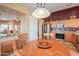 Open floor plan showing the kitchen with granite counters and dining area with a round wood table at 426 N Santiago Trl, Casa Grande, AZ 85194