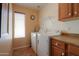 Laundry room featuring a washer and dryer, shelf, and cabinets at 426 N Santiago Trl, Casa Grande, AZ 85194