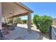 This is a covered patio with a dining table, chairs, decorative rock, and a grassy yard at 426 N Santiago Trl, Casa Grande, AZ 85194