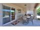 Covered patio with a tile table, chairs, sliding glass doors, and decorative rug at 426 N Santiago Trl, Casa Grande, AZ 85194