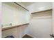 A walk-in closet with hanging racks, shelving, carpet floors, and neutral paint at 426 N Santiago Trl, Casa Grande, AZ 85194