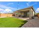 Backyard featuring a covered patio, synthetic grass, perimeter block fencing, and brick paver patio at 460 W Glacier Bay Dr, San Tan Valley, AZ 85140