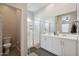 Clean bathroom with a double vanity, large mirror, and glass-enclosed shower with a shower caddy at 460 W Glacier Bay Dr, San Tan Valley, AZ 85140