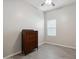 Bedroom with wood-look tile flooring, neutral walls, and a wooden chest of drawers at 460 W Glacier Bay Dr, San Tan Valley, AZ 85140