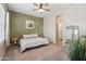 Serene bedroom with an olive accent wall, neutral bedding, and a stylish full-length mirror at 460 W Glacier Bay Dr, San Tan Valley, AZ 85140