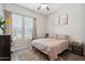 Bright bedroom showcasing a soft rug, stylish window, and comfortable bed with neutral bedding at 460 W Glacier Bay Dr, San Tan Valley, AZ 85140