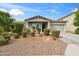 Inviting single-Gathering home featuring desert landscaping, a well-manicured front yard, and a cozy front porch at 460 W Glacier Bay Dr, San Tan Valley, AZ 85140