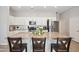 Bright kitchen features white cabinets, stainless steel appliances, and an island with granite countertops at 460 W Glacier Bay Dr, San Tan Valley, AZ 85140