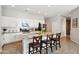 Well-designed kitchen boasts white cabinets, granite countertops, and a large island with seating at 460 W Glacier Bay Dr, San Tan Valley, AZ 85140