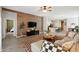 Stylish living room features a wood accent wall, modern furniture, and an open layout to the kitchen at 460 W Glacier Bay Dr, San Tan Valley, AZ 85140
