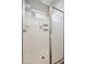 Modern shower with glass door, bright white shower walls, and convenient built-in storage shelves at 460 W Glacier Bay Dr, San Tan Valley, AZ 85140