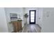Inviting entryway features wood-look floors, a modern accent table, and an abundance of natural light at 5007 N 71St Dr, Glendale, AZ 85303