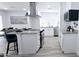 Open-concept kitchen with stainless steel appliances, an island, and bright white cabinetry and countertops at 5007 N 71St Dr, Glendale, AZ 85303