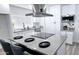 Bright kitchen boasts stainless steel appliances, a large island with bar seating, and white cabinetry at 5007 N 71St Dr, Glendale, AZ 85303
