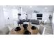 Open-concept living space with modern furnishings, island with bar seating, and a fireplace at 5007 N 71St Dr, Glendale, AZ 85303