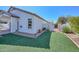 Well-maintained backyard featuring synthetic grass, a privacy wall, and desert landscaping at 5226 W Pontiac Dr, Glendale, AZ 85308