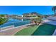 Beautiful backyard with a gorgeous water view, artificial grass and gravel at 5226 W Pontiac Dr, Glendale, AZ 85308