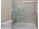 Bathroom with shower and bathtub featuring a glass sliding door and granite walls at 5226 W Pontiac Dr, Glendale, AZ 85308