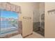 Bathroom boasts a walk-in glass shower and a window with a beautiful lake view at 5226 W Pontiac Dr, Glendale, AZ 85308