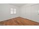 Bedroom with wood floors, plantation shutters, and a closet with sliding doors at 5226 W Pontiac Dr, Glendale, AZ 85308