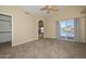 Spacious main bedroom with neutral carpet, sliding glass doors to back patio, and en-suite bath at 5226 W Pontiac Dr, Glendale, AZ 85308