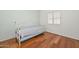 Bedroom showcases wood floors, white walls, and a day bed with a white frame at 5226 W Pontiac Dr, Glendale, AZ 85308