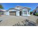 Charming home featuring a well-manicured front yard, two-car garage, desert landscaping and brick entryway at 5226 W Pontiac Dr, Glendale, AZ 85308
