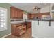 Traditional kitchen with brown cabinets, stainless steel appliances, and black countertops at 5226 W Pontiac Dr, Glendale, AZ 85308