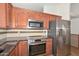 Close up of kitchen featuring granite countertops, stainless appliances and custom tile backsplash at 5226 W Pontiac Dr, Glendale, AZ 85308