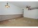 Inviting living room featuring carpeted floors, high ceilings, ceiling fans, natural light and wood paneled wall at 5226 W Pontiac Dr, Glendale, AZ 85308