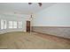 Inviting living room featuring carpeted floors, high ceilings, natural light, wood paneled wall and chandelier at 5226 W Pontiac Dr, Glendale, AZ 85308