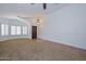 Cozy living room featuring neutral carpet, tile entry, and bright natural light at 5226 W Pontiac Dr, Glendale, AZ 85308