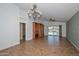 Bright room with chandelier, tile floors, view to backyard and access to kitchen at 5226 W Pontiac Dr, Glendale, AZ 85308
