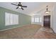 Inviting living room with plush carpet, shuttered windows and decorative tile entry at 5226 W Pontiac Dr, Glendale, AZ 85308