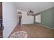 Spacious living room with neutral carpet, tile entry, and view to other living area at 5226 W Pontiac Dr, Glendale, AZ 85308