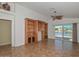 Open living room with built-in shelves and sliding doors to patio with views of water at 5226 W Pontiac Dr, Glendale, AZ 85308