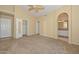 Large main bedroom with carpet and a bathroom entrance with an arched doorway at 5226 W Pontiac Dr, Glendale, AZ 85308
