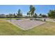 Sandy volleyball court surrounded by lush green grass in a well-maintained community park at 5226 W Pontiac Dr, Glendale, AZ 85308