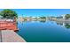 Scenic view of canal with neighboring homes and boat docks on a clear sunny day at 5226 W Pontiac Dr, Glendale, AZ 85308