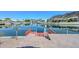 Backyard waterfront view of the canal featuring a dock and beautiful Arizona mountain views at 5226 W Pontiac Dr, Glendale, AZ 85308
