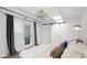 Bright bedroom with a sliding barn door, ample natural light, and a chandelier at 5809 N 10Th Pl, Phoenix, AZ 85014