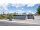Exterior view of the home with a well-kept lawn, decorative fencing, and a garage at 5809 N 10Th Pl, Phoenix, AZ 85014