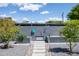 Charming front yard featuring a decorative gate, stone pathway, and manicured landscaping at 5809 N 10Th Pl, Phoenix, AZ 85014