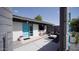 Charming front yard with desert landscaping, light gray patio, and a vibrant turquoise door at 5809 N 10Th Pl, Phoenix, AZ 85014