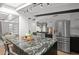 Bright, open kitchen featuring stainless steel appliances and a large granite island at 5809 N 10Th Pl, Phoenix, AZ 85014