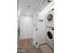 Laundry area with stacked washer/dryer and space-saving storage shelves at 5809 N 10Th Pl, Phoenix, AZ 85014