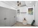 Organized storage room with built-in cabinets, tiled floor, and bright lighting at 5809 N 10Th Pl, Phoenix, AZ 85014