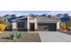 Charming single-story home features a neutral color palette, desert landscaping, and an attached two-car garage at 5824 E Axle Ln, San Tan Valley, AZ 85140